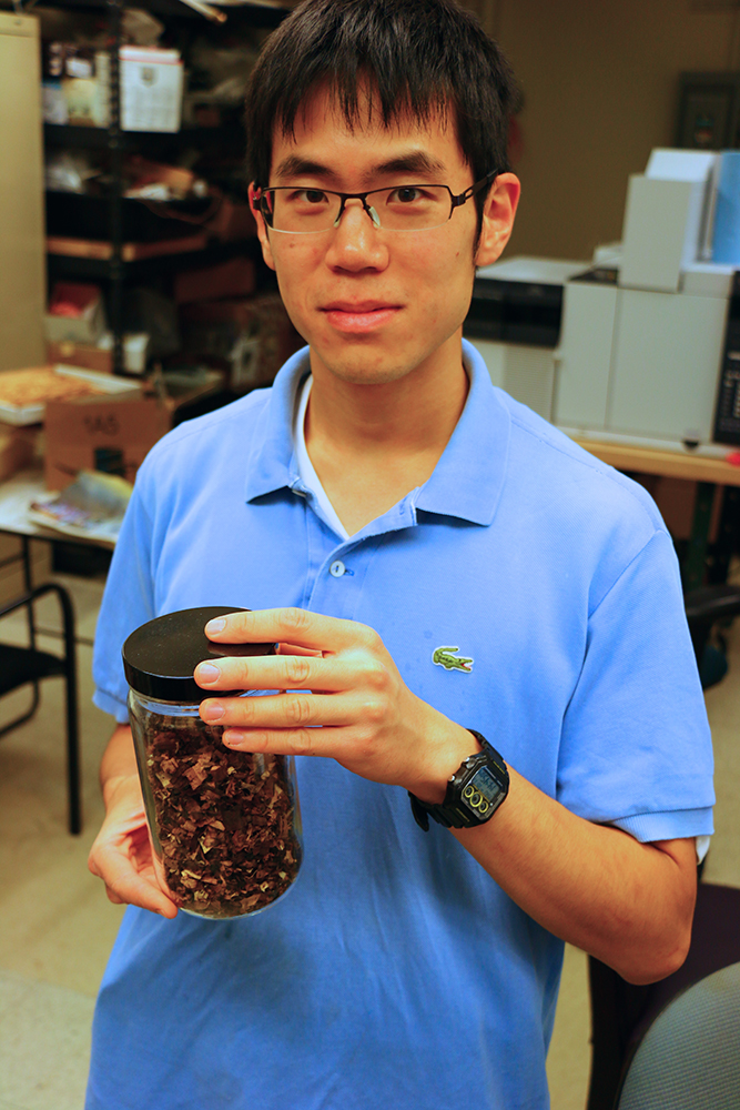 Here Tata Fellow Kevin Kung displays a jar of torrefied biomass—agricultural waste that has undergone thermochemical treatment in the torrefaction reactor to increase its energy density. Photo: Ben Miller, MIT