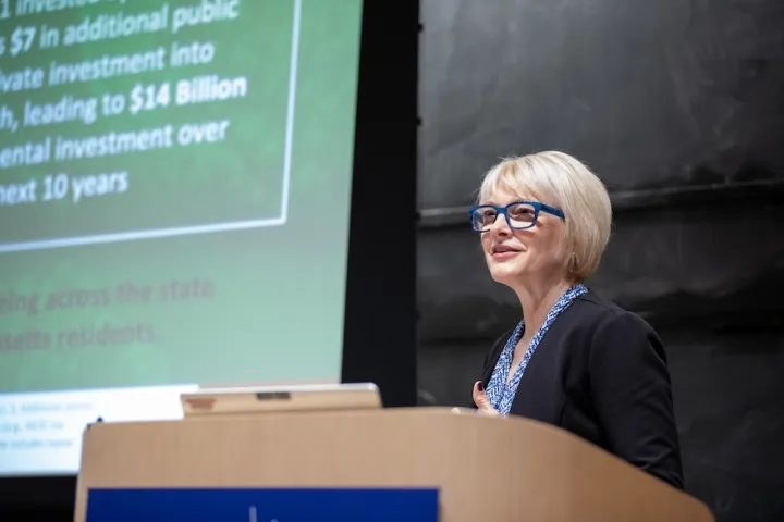 Emily Reichert, CEO of the Massachusetts Clean Energy Center, speaks at a podium during a MIT Energy Initiative seminar.