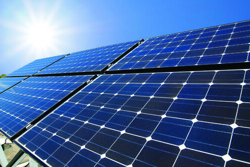solar panels with sun shining on them from above